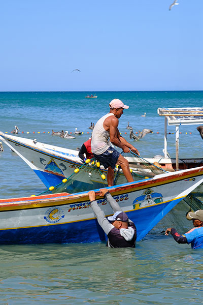 Artisanal fishers preparing their nets near the shore